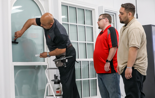 Trainer showing how to properly install architectural window film. 